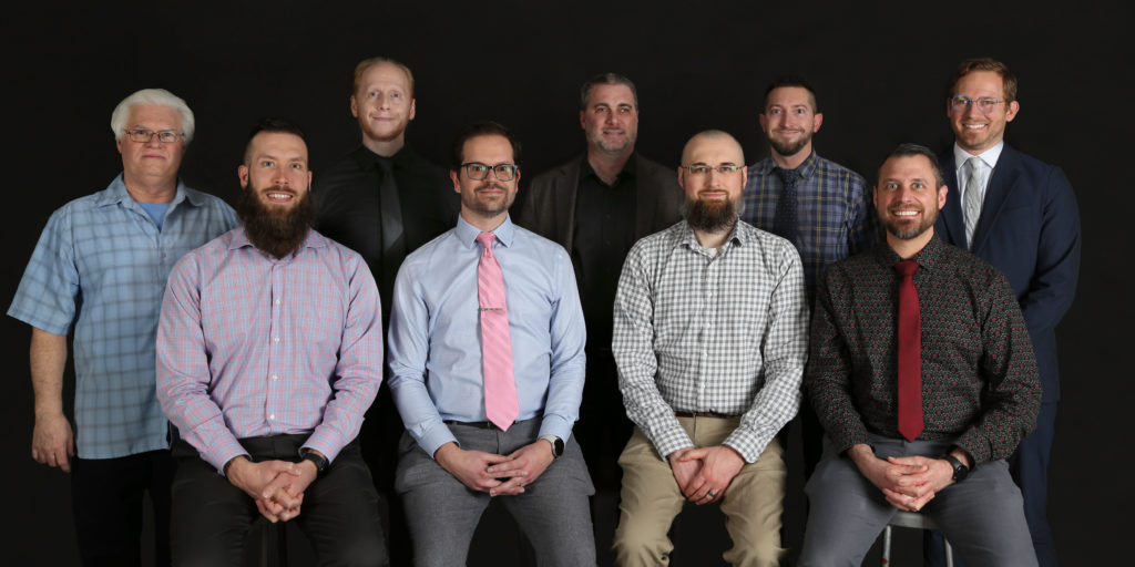 An image of the Arts & Letters Computing team standing or sitting in two rows.