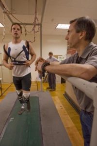 Oscar Pristorius strapped into a harness and being tested on a treadmill by Alena Grabowski's research team.