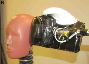 Boxing glove on piston delivering punch to a crash test dummy head