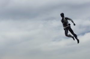 Stuntronics robot soaring through air while holding heroic pose