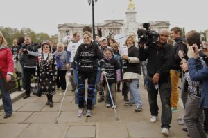 Claire Lomas surrounded by supporters as she walks the 2012 London Marathon