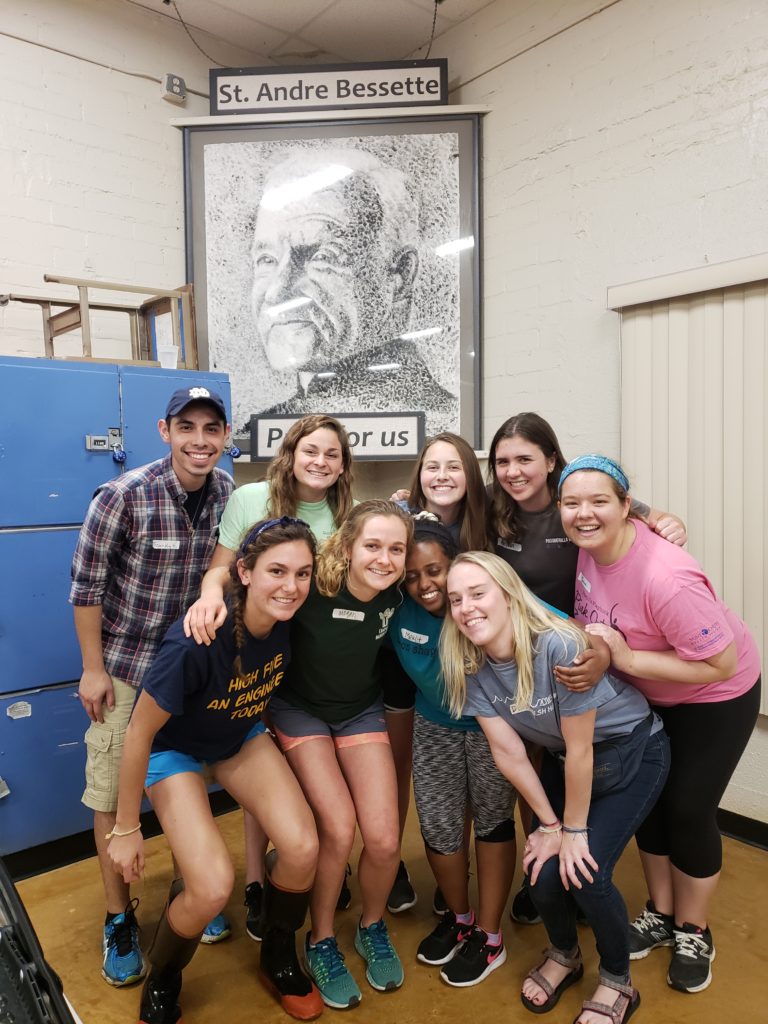 Notre Dame's fall break group pictured with an image of St. André Bessette.