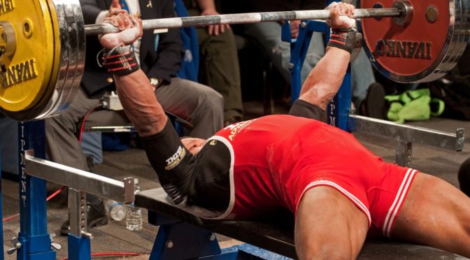 Man about to perform the bench press in competition.