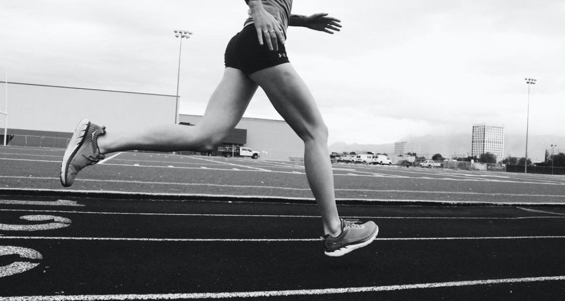Image of the bottom half of a female runner on a track