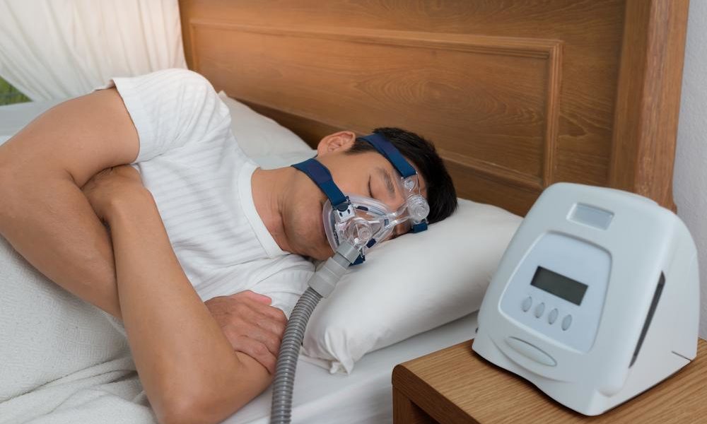 Man sleeping while using CPAP machine