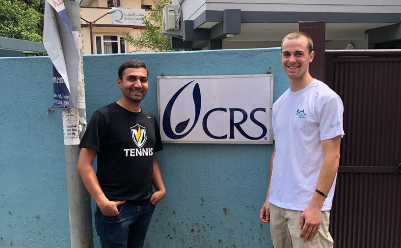 Ramchandra and Brian Hickey in front of a Catholic Relief Services building in Nepal.