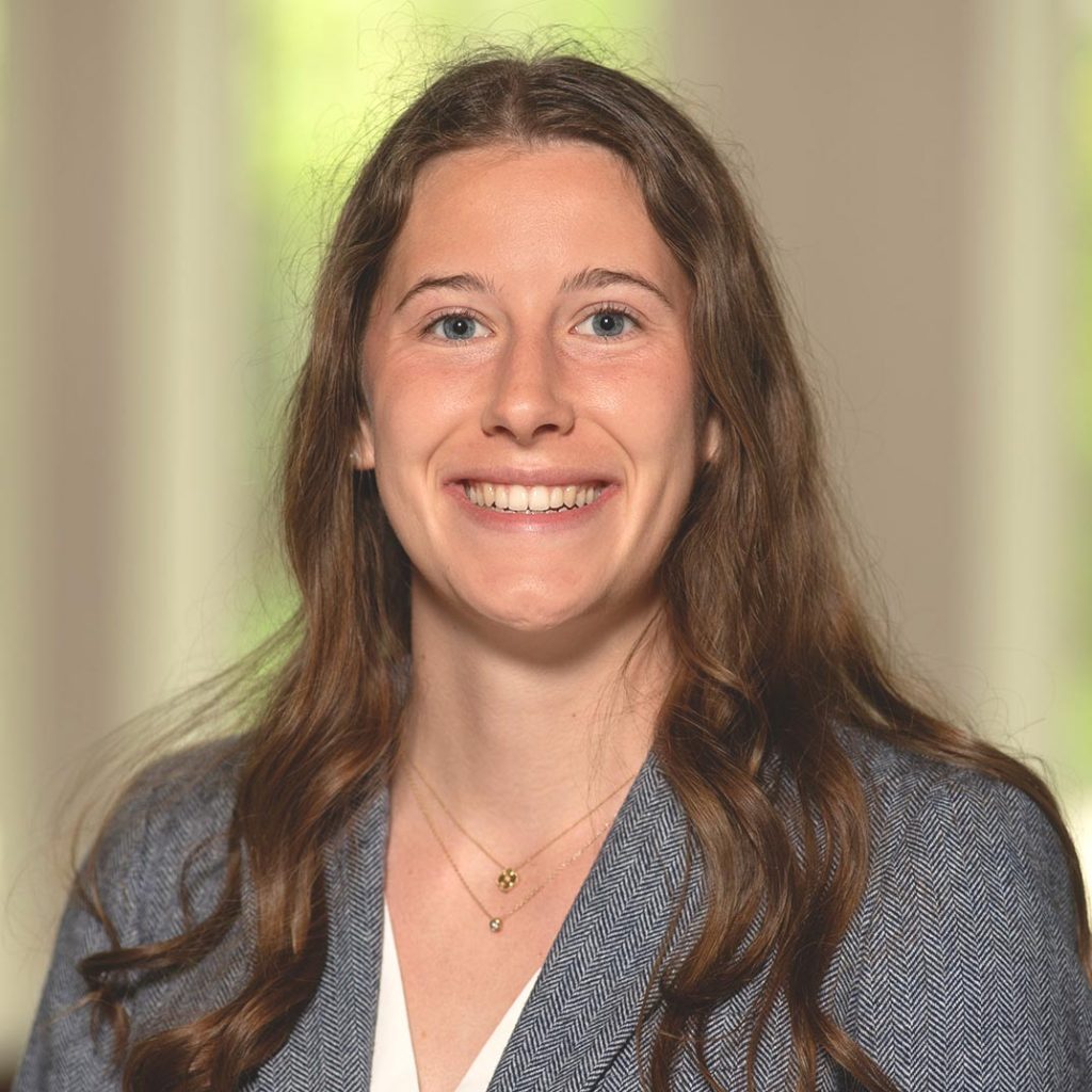 Portrait of Allie Sproul, President of Notre Dame SWE, smiling and wearing a gray blazer over a white blouse.