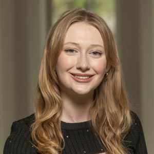 Portrait of Eva Talkington, Co-Treasurer of Notre Dame SWE, smiling and wearing a black sweater.